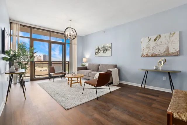 a living room with furniture a window and a flat screen tv