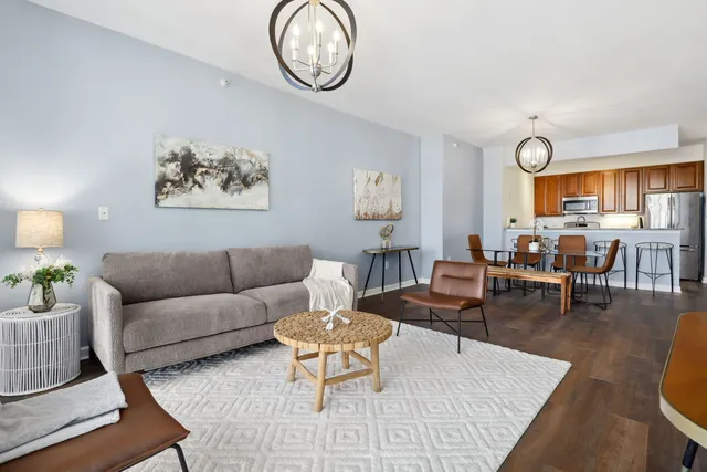 a living room with furniture a rug and a window