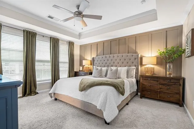 a bedroom with a bed and a night stand