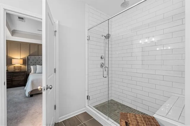a en suite bathroom with a granite countertop sink and a mirror