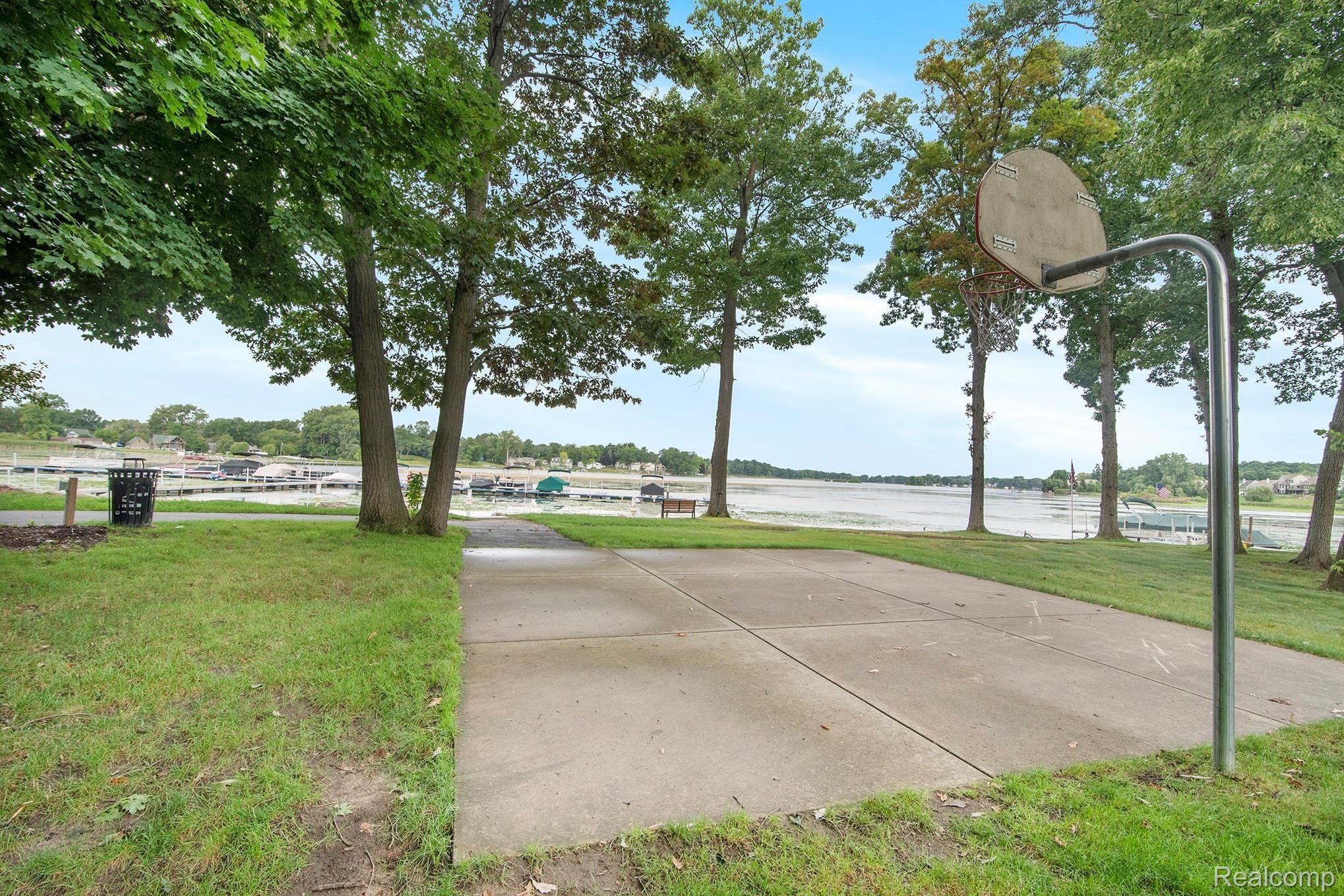 2524 Ravine Side North Howell, MI 48843 - Photo 29 of 31 community basketball court, picnic area, dock, and beach