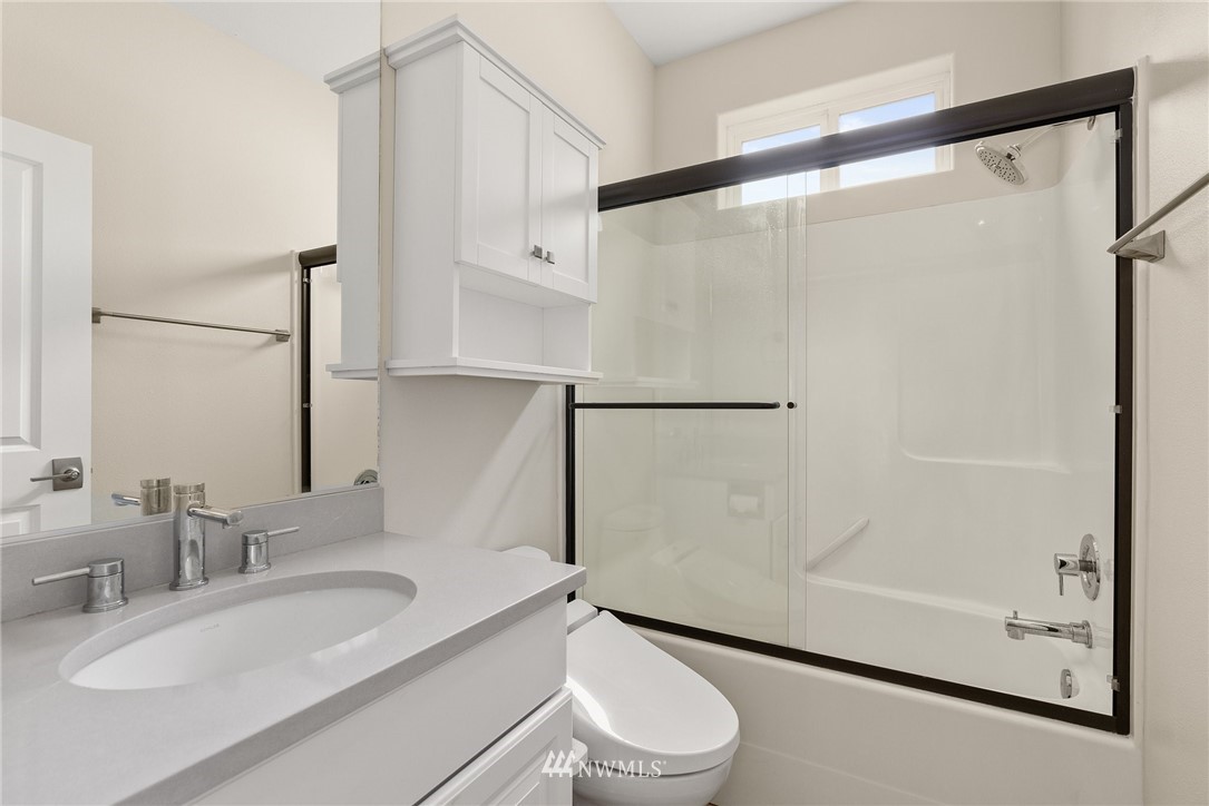 18622 Melon Street Southwest Rochester, WA 98579 - Photo 17 of 33 a bathroom with a sink a mirror and a shower