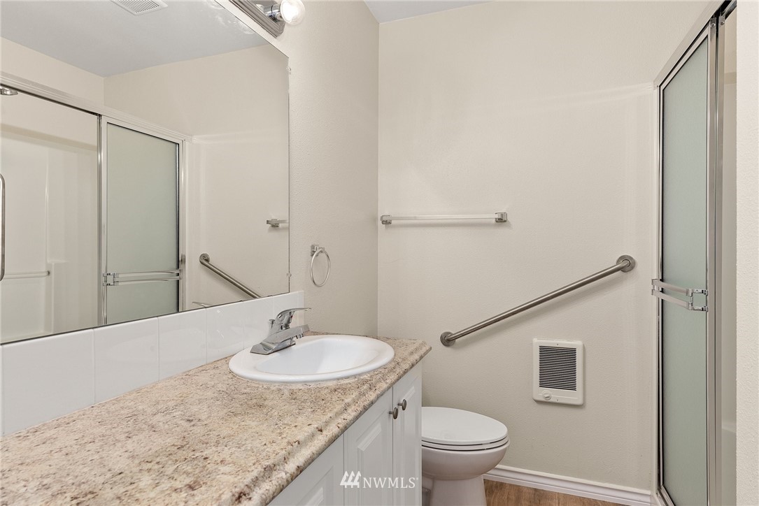18622 Melon Street Southwest Rochester, WA 98579 - Photo 27 of 33 a bathroom with a granite countertop sink a toilet and a mirror
