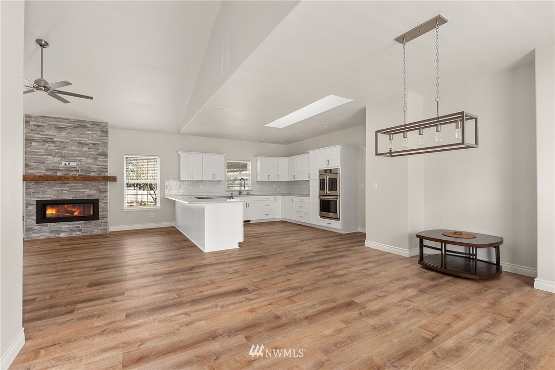 18622 Melon Street Southwest Rochester, WA 98579 - Photo 6 of 33 a view of kitchen and empty room with wooden floor