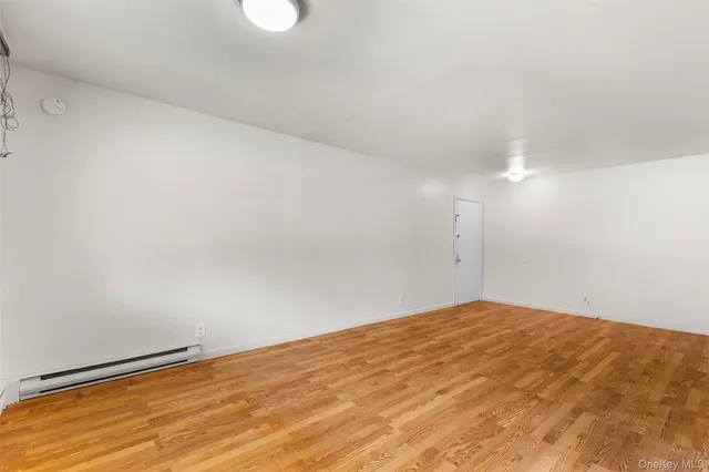 a view of a room with a cabinet and refrigerator