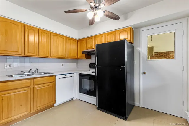 a view of a bathroom with shower and mirror