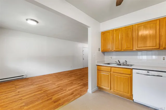 a kitchen with stainless steel appliances granite countertop a refrigerator a stove and a sink