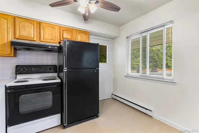 a view of a kitchen with wooden floor and a sink