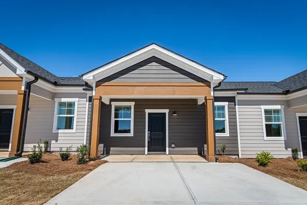 a front view of a house with a yard