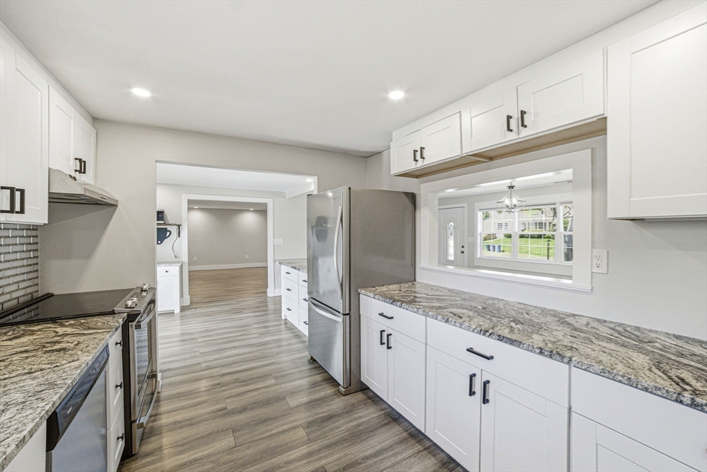 157 Errol Road Brockton, MA 02302 - Photo 19 of 34 a kitchen with stainless steel appliances granite countertop a sink and wooden cabinets
