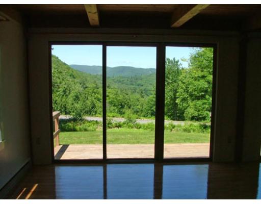 9 Stone Road Buckland, MA 01370 - Photo 8 of 9 a view of an empty room with wooden floor and floor to ceiling windows