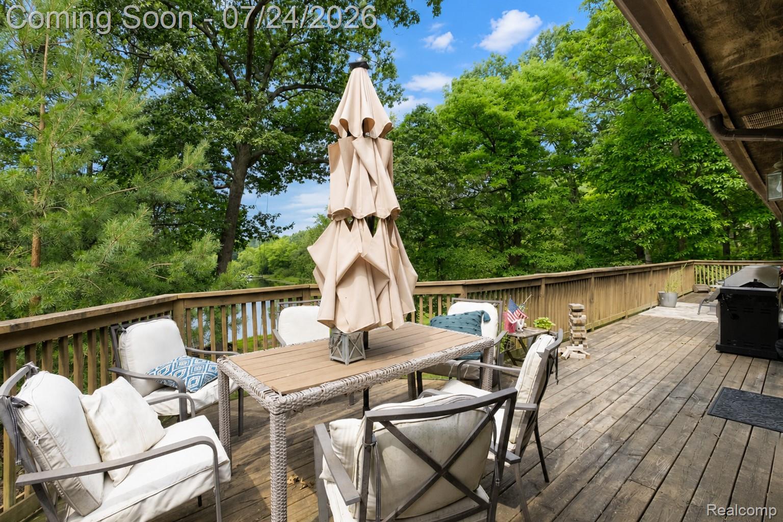 377 Ridgemont Road Oxford, MI 48370 - Photo 23 of 52 Expansive wooden deck with a slatted railing, providing extensive outdoor living space