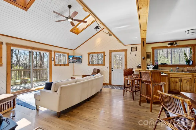 a living room with furniture wooden floor and a table