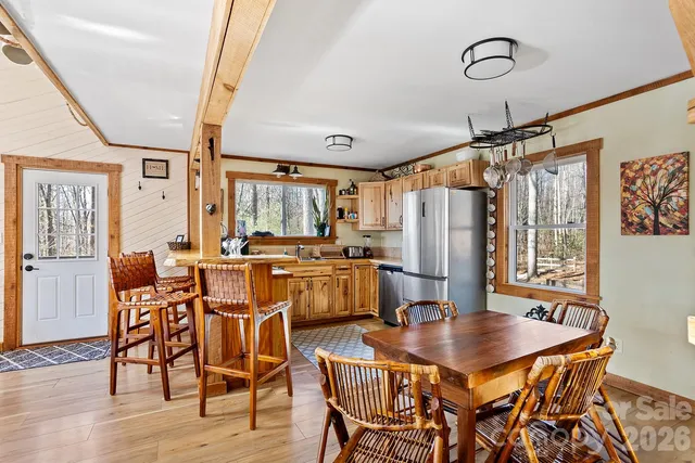 a dining room with furniture window and wooden floor
