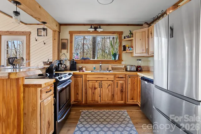 a kitchen with stainless steel appliances granite countertop a stove a refrigerator and a sink