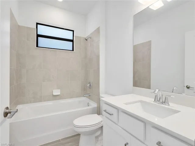 a bathroom with a sink a toilet and a bathtub