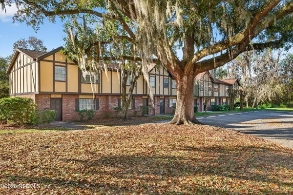 a large tree in front of a house