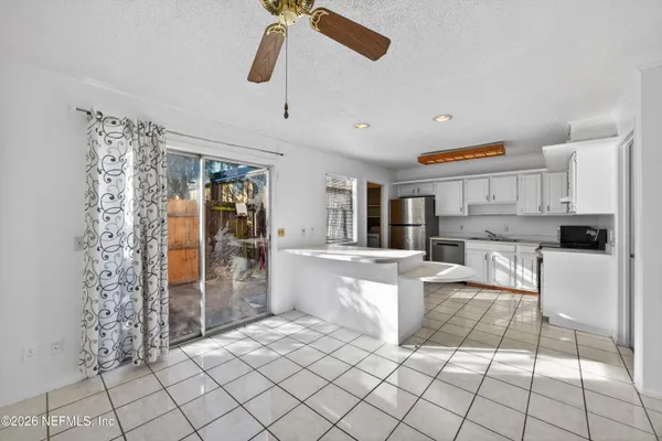 a large white kitchen with cabinets