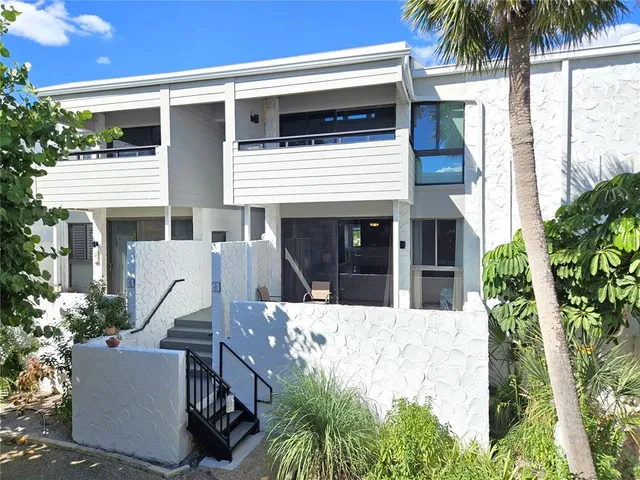 a view of a house with a yard and sitting area