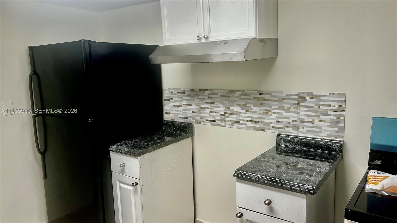 3560 Southwest 25th Terrace Miami, FL 33133 - Photo 5 of 12 a kitchen with appliances cabinets and a counter top space