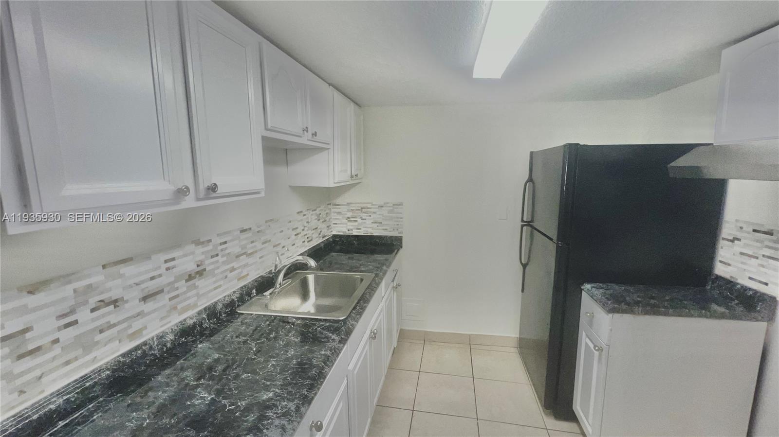 3560 Southwest 25th Terrace Miami, FL 33133 - Photo 6 of 12 a kitchen with stainless steel appliances granite countertop a refrigerator and a stove