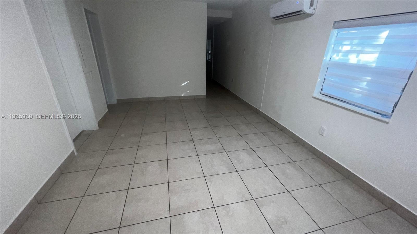 3560 Southwest 25th Terrace Miami, FL 33133 - Photo 7 of 12 a view of an empty room with a window