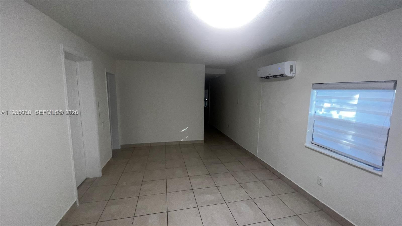 3560 Southwest 25th Terrace Miami, FL 33133 - Photo 8 of 12 a view of an empty room and window