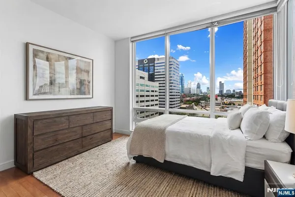 a bedroom with a large bed and a chandelier