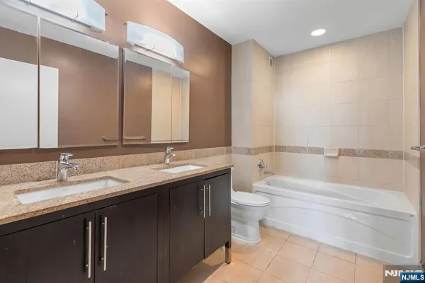 a bathroom with a double vanity sink and a toilet