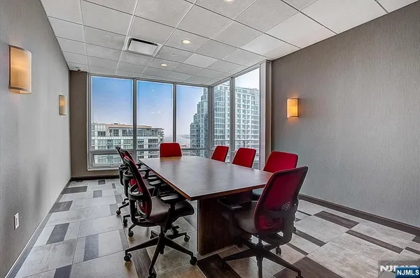 a living room with furniture a chandelier and a rug