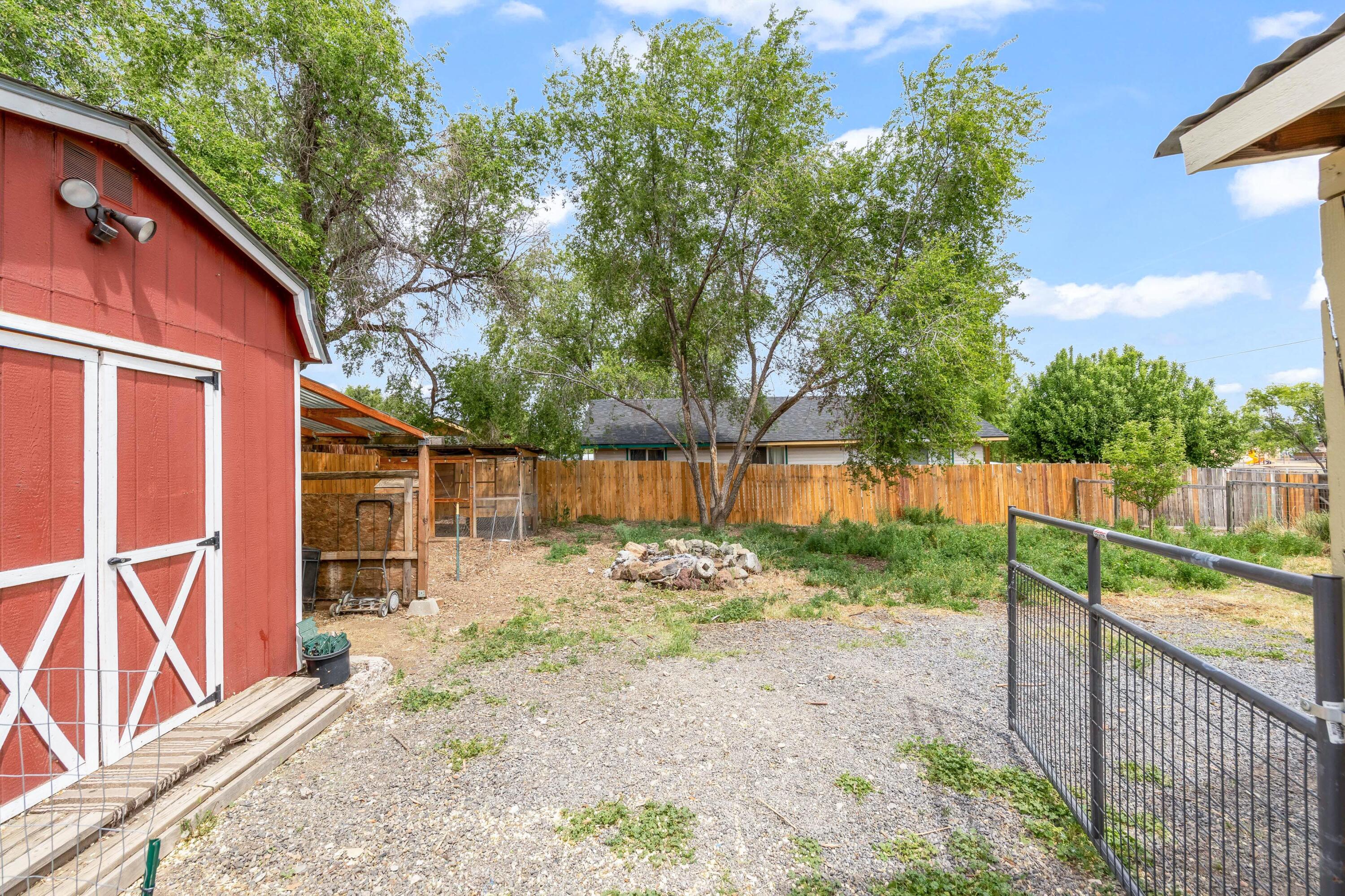 496 Southwest 2nd Street Madras, OR 97741 - Photo 28 of 37 a view of a backyard with wooden fence and large trees