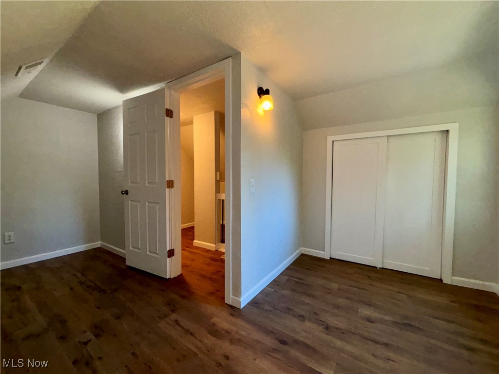 3522 Tent Church Road Colliers, WV 26035 - Photo 12 of 27 Additional living space with dark wood-style flooring and vaulted ceiling