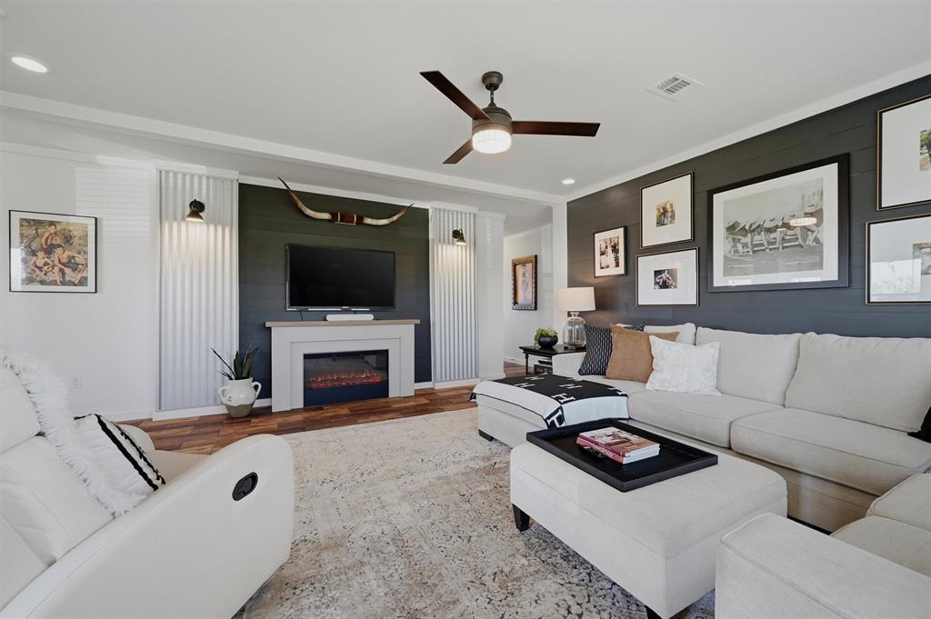249 Mt Pleasant Road Valley View, TX 76272 - Photo 14 of 40 a living room with furniture a fireplace and a flat screen tv