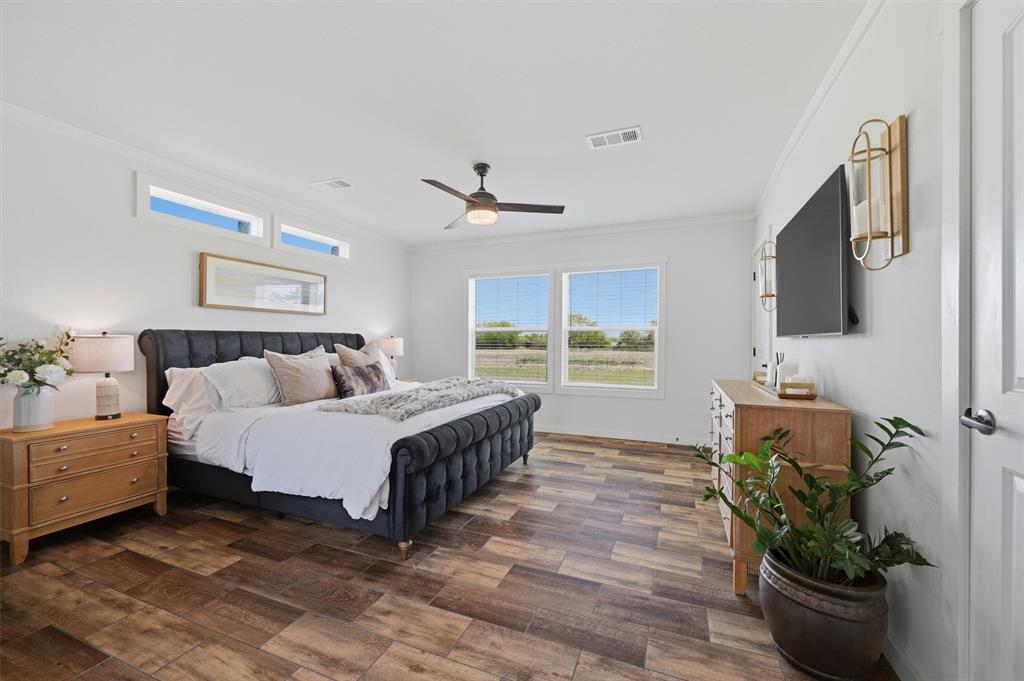 249 Mt Pleasant Road Valley View, TX 76272 - Photo 22 of 40 a spacious bedroom with a bed and a flat screen tv