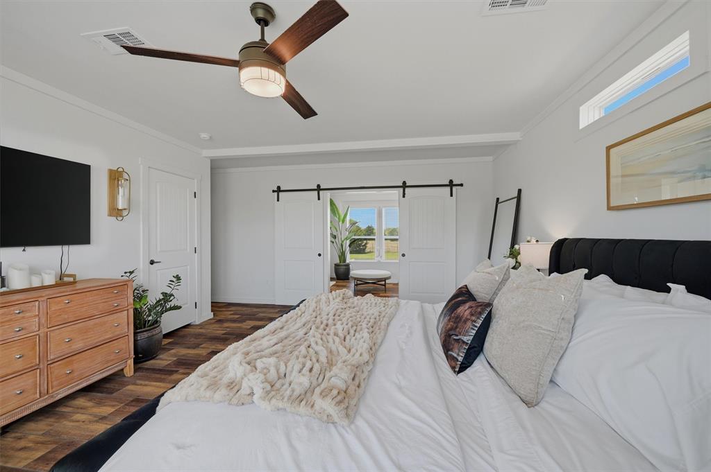 249 Mt Pleasant Road Valley View, TX 76272 - Photo 26 of 40 a bedroom with a bed and a flat tv screen on dresser