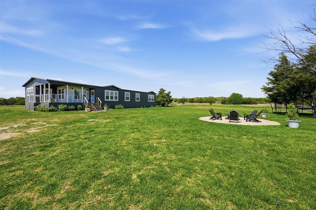 249 Mt Pleasant Road Valley View, TX 76272 - Photo 3 of 40 a view of a big yard with a house in the background