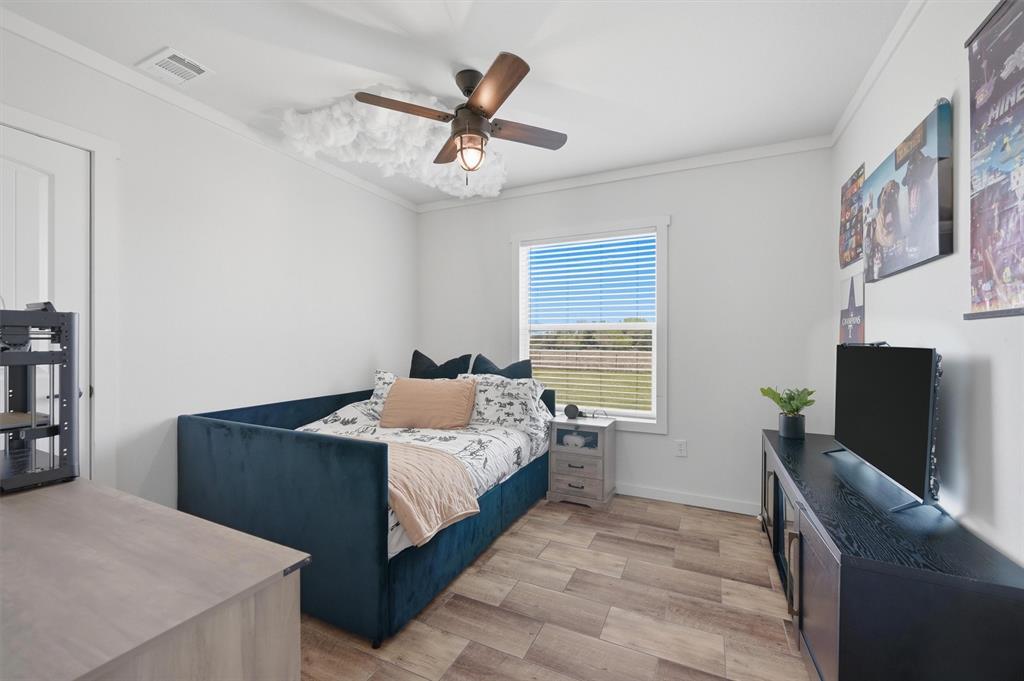 249 Mt Pleasant Road Valley View, TX 76272 - Photo 31 of 40 a bedroom with a bed and a flat screen tv