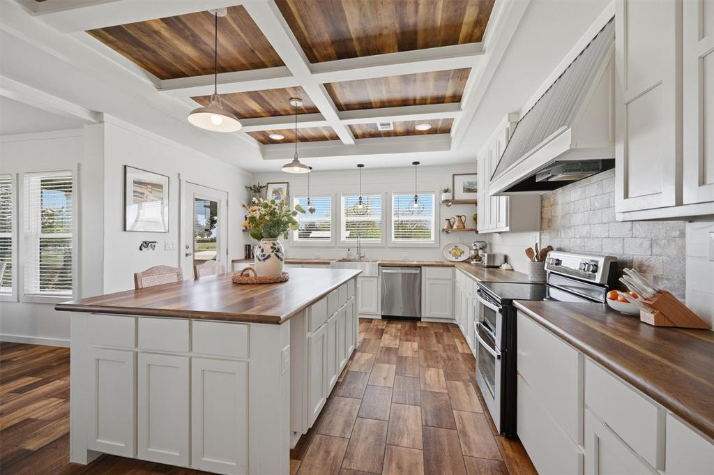 249 Mt Pleasant Road Valley View, TX 76272 - Photo 8 of 40 a kitchen with stainless steel appliances granite countertop a sink a stove and cabinets