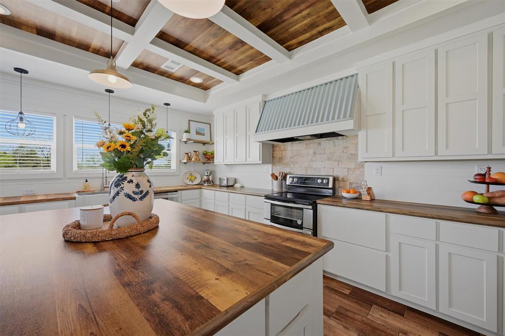 249 Mt Pleasant Road Valley View, TX 76272 - Photo 9 of 40 a kitchen with stainless steel appliances granite countertop a sink a stove and cabinets