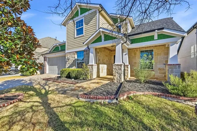 a view of a house with a yard and pathway