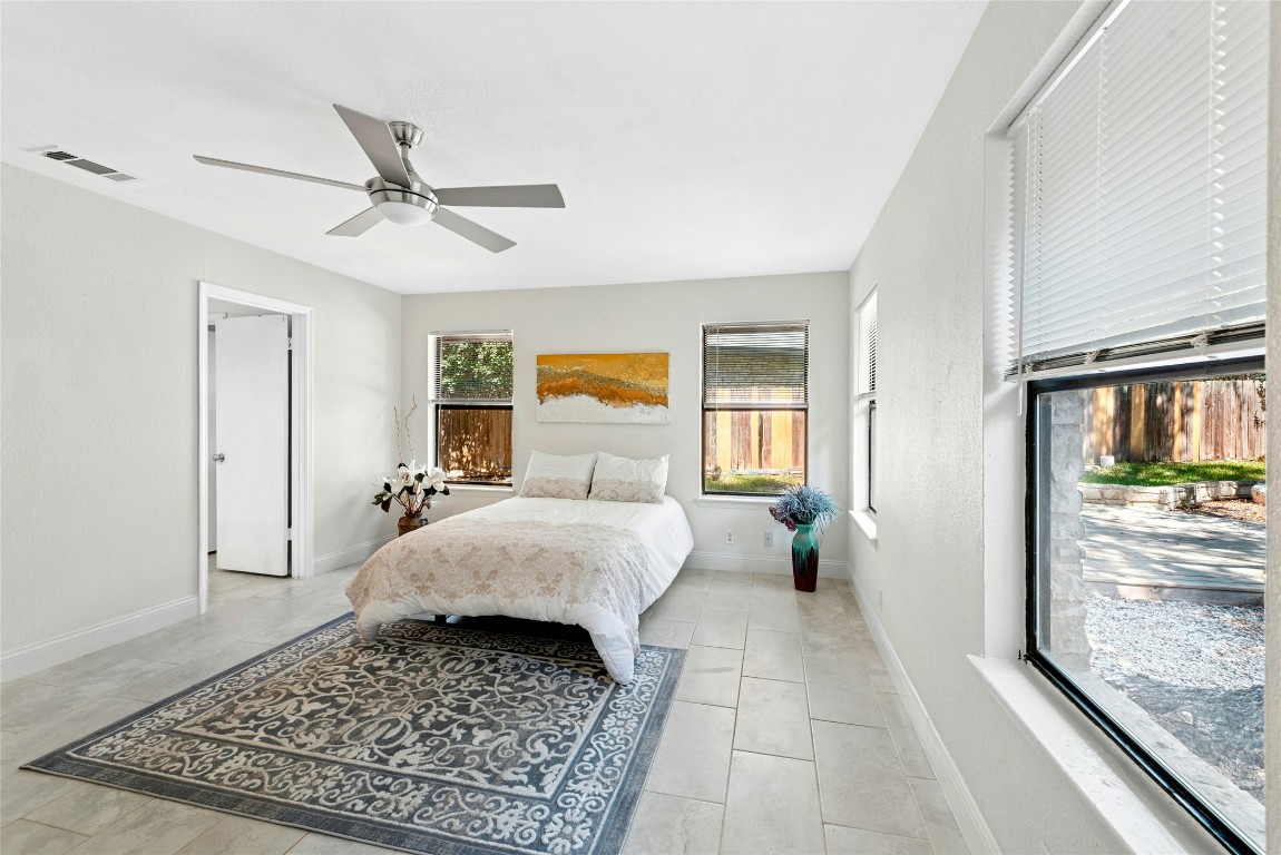 6906 Bayridge Terrace Austin, TX 78759 - Photo 17 of 35 a bed room with a bed and wooden floor