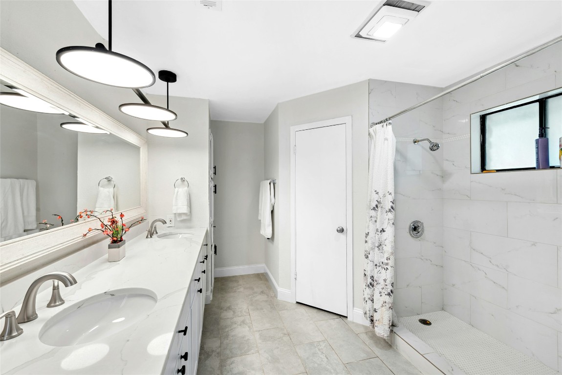 6906 Bayridge Terrace Austin, TX 78759 - Photo 20 of 35 a bathroom with a sink and shower