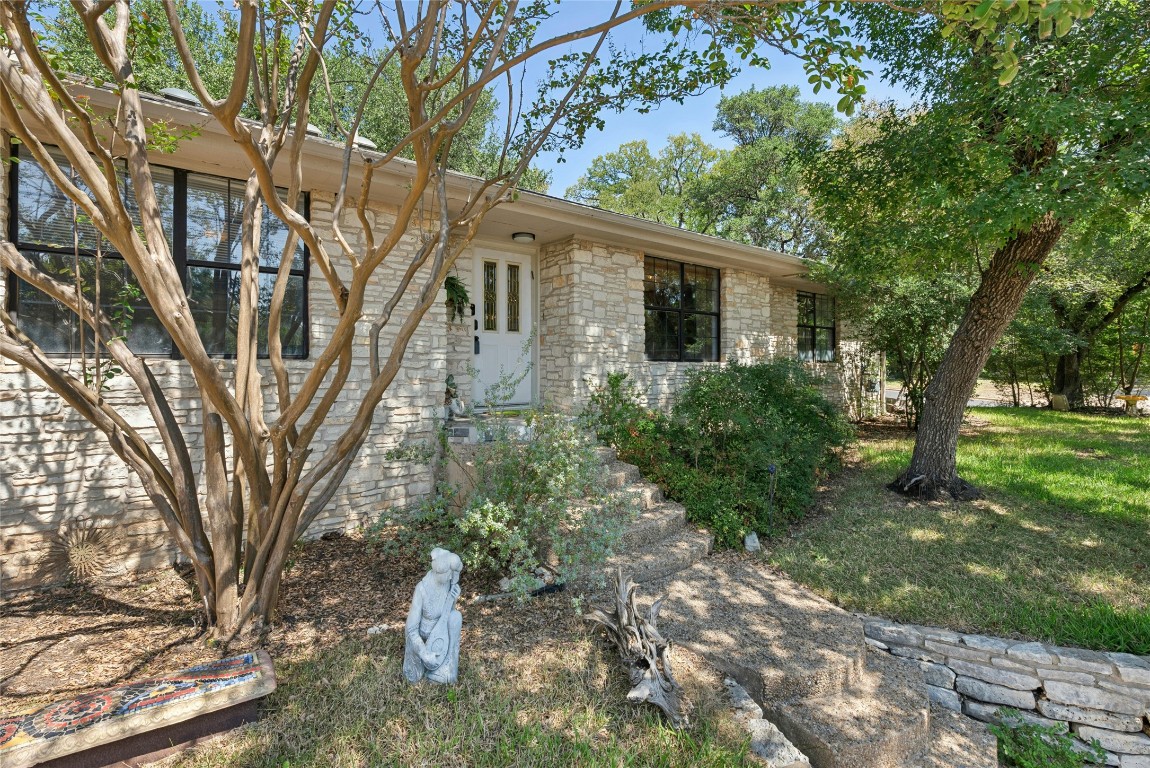 6906 Bayridge Terrace Austin, TX 78759 - Photo 2 of 35 a backyard of a house with lots of green space