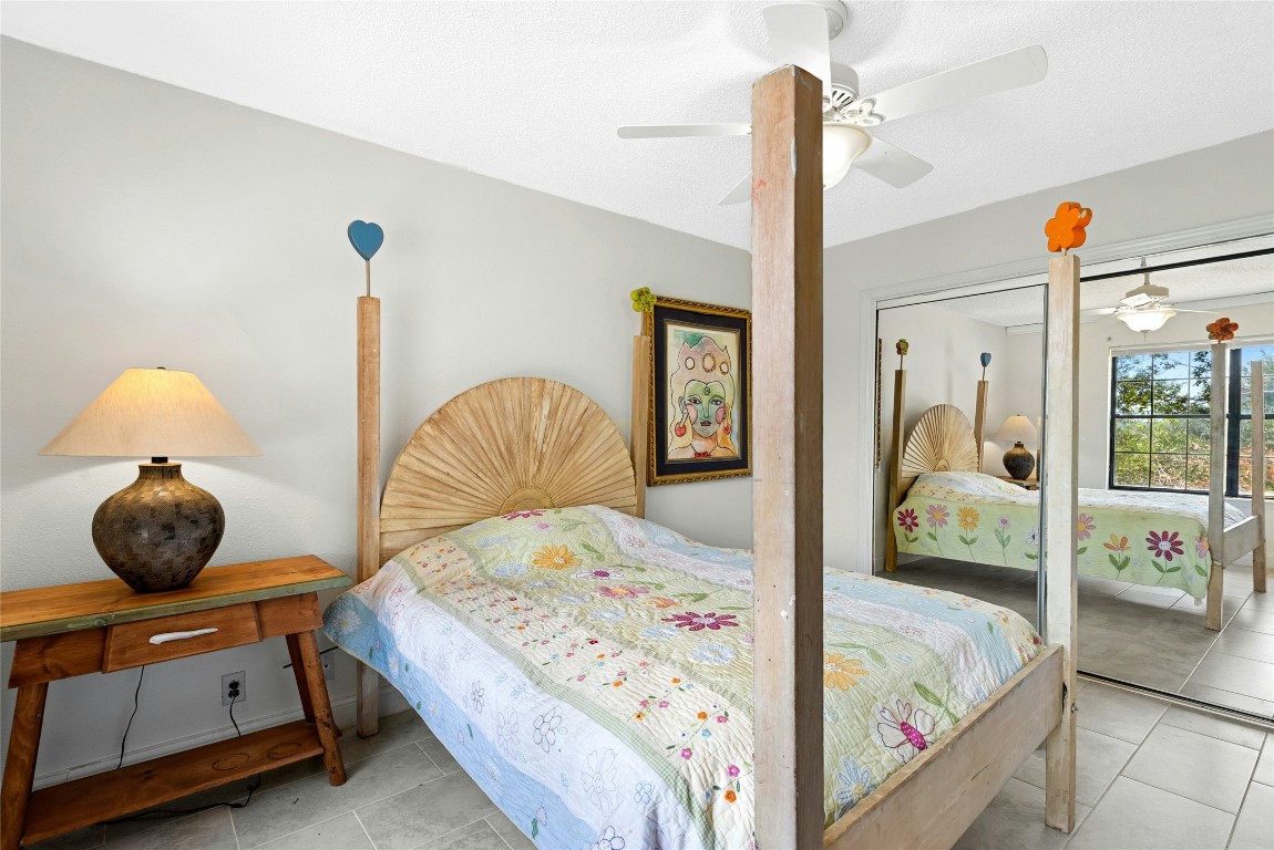 6906 Bayridge Terrace Austin, TX 78759 - Photo 25 of 35 a bedroom with a bed and window