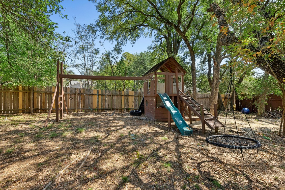 6906 Bayridge Terrace Austin, TX 78759 - Photo 32 of 35 a view of a backyard with a table and chairs