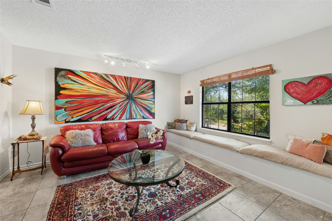 6906 Bayridge Terrace Austin, TX 78759 - Photo 5 of 35 a living room with furniture and a potted plant