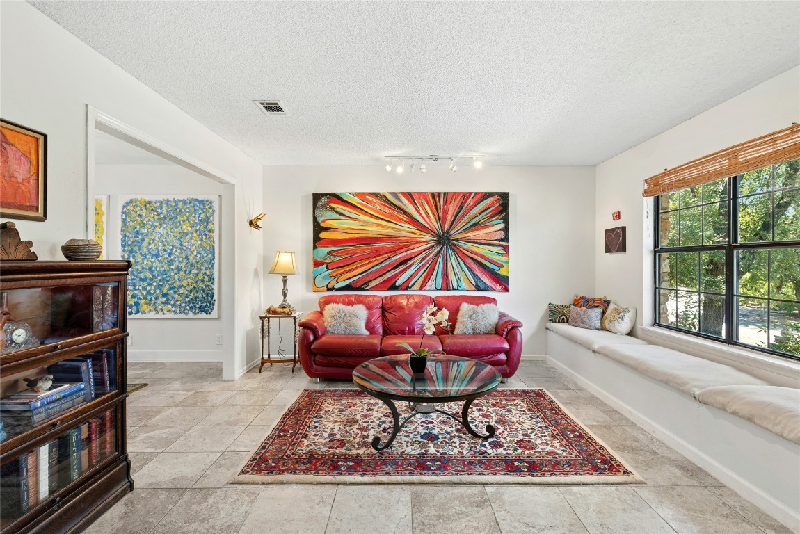 6906 Bayridge Terrace Austin, TX 78759 - Photo 6 of 35 a living room with furniture a rug and a large window