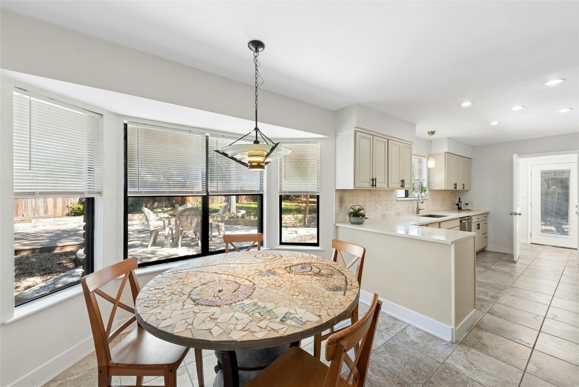 6906 Bayridge Terrace Austin, TX 78759 - Photo 9 of 35 a open kitchen with a table and chairs in it