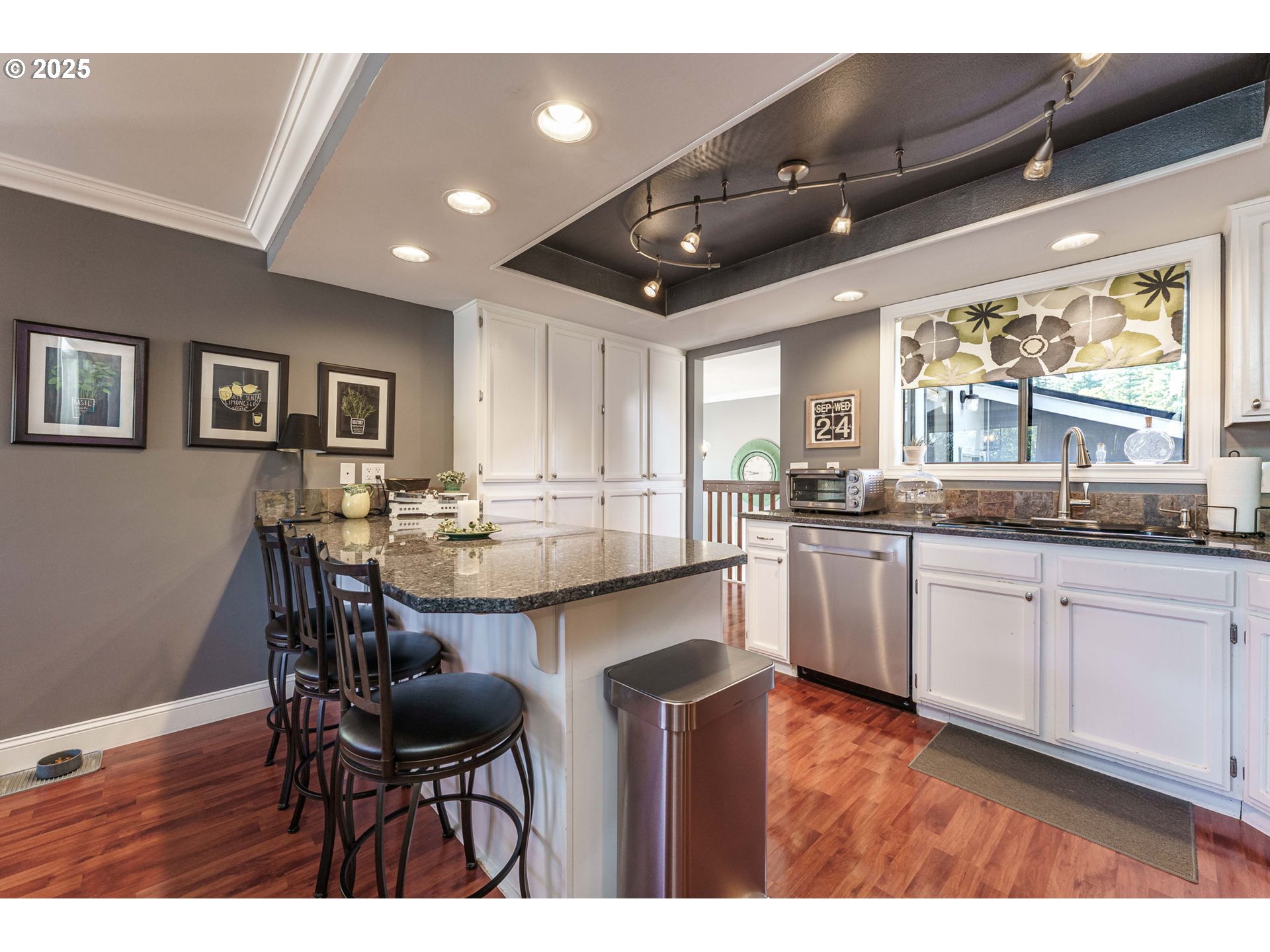 737 Northwest 20th Avenue Camas, WA 98607 - Photo 13 of 40 a open kitchen with stainless steel appliances granite countertop a stove top oven a sink a dining table and chairs