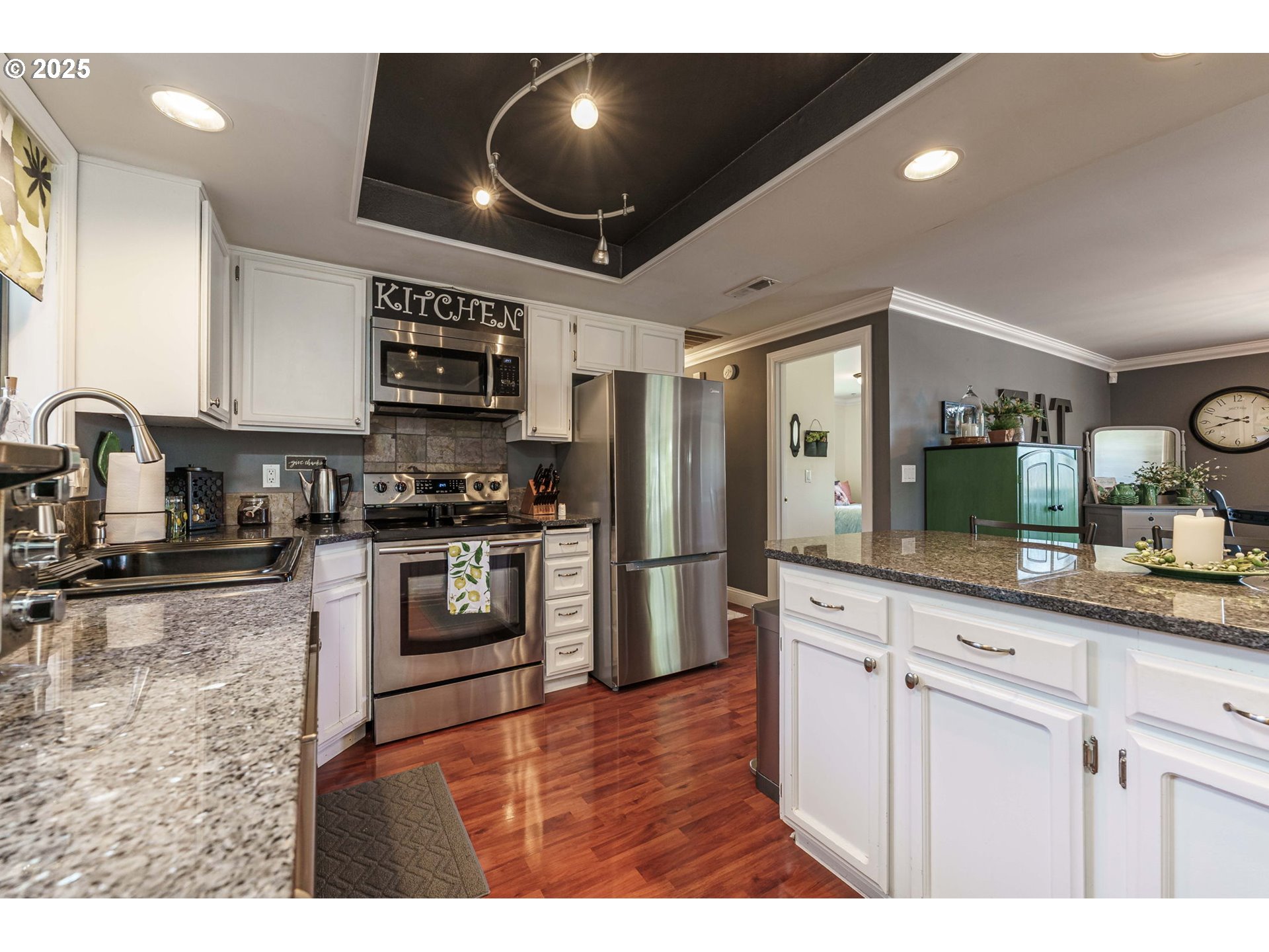 737 Northwest 20th Avenue Camas, WA 98607 - Photo 14 of 40 a kitchen with stainless steel appliances kitchen island granite countertop a refrigerator a stove and a sink with granite countertops